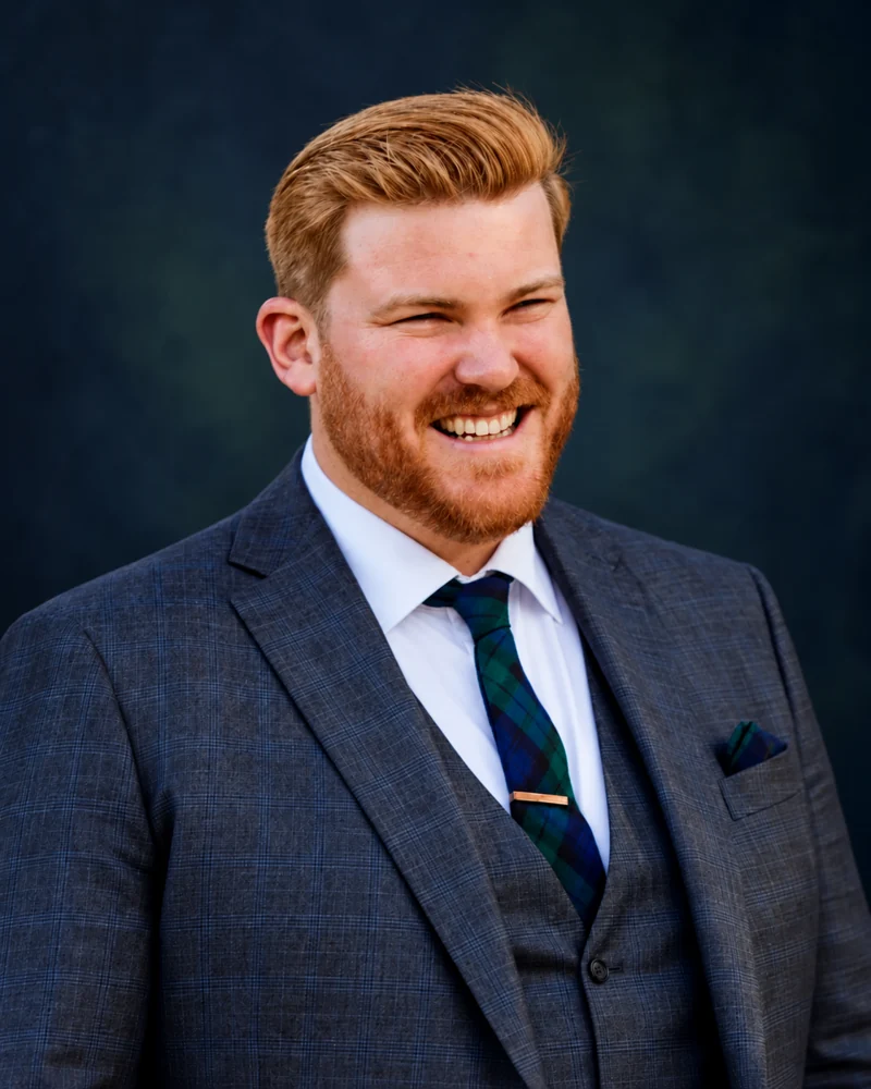 Sean Riordan, owner and principal consultant of Riordan Physical Risk, wearing a navy suit and green tartan tie